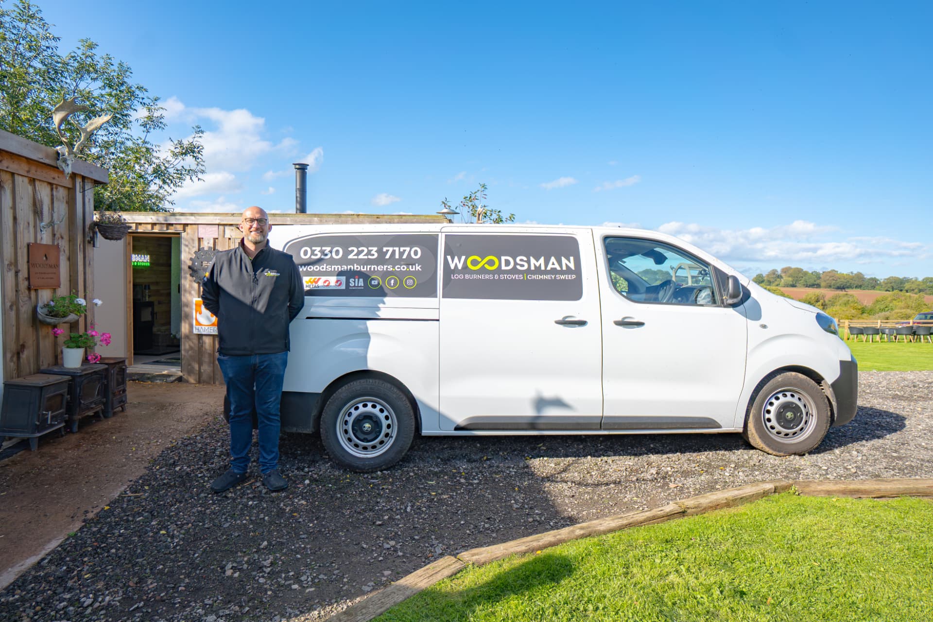 Mike from Woodsman Log Burners outside the showroom with his van